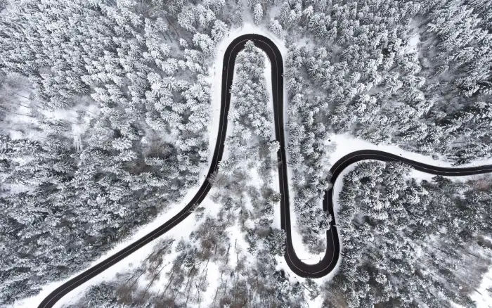 Aerial View Snow Covered Forest Road Background