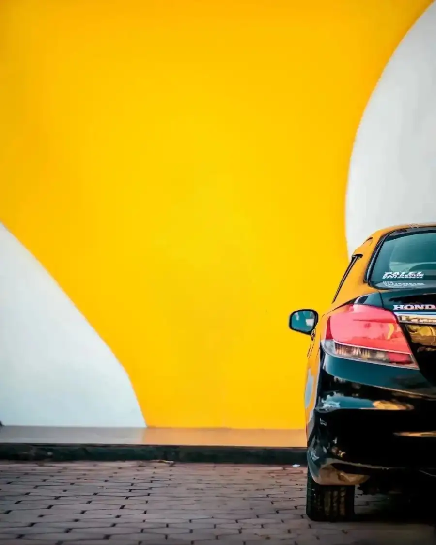 CB Car Parked In Front Of A Yellow Wall Background