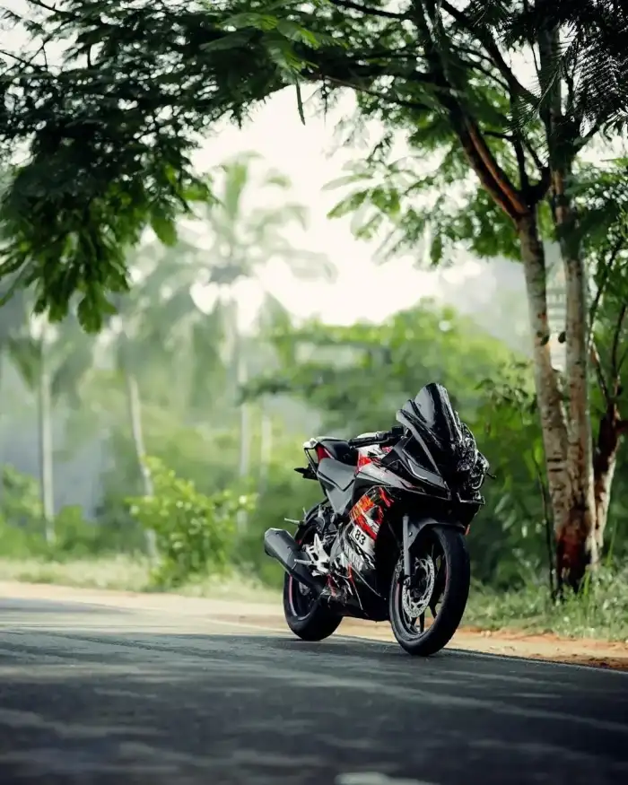 CB Editing Motorcycle Parked On The Side Of A Road Background