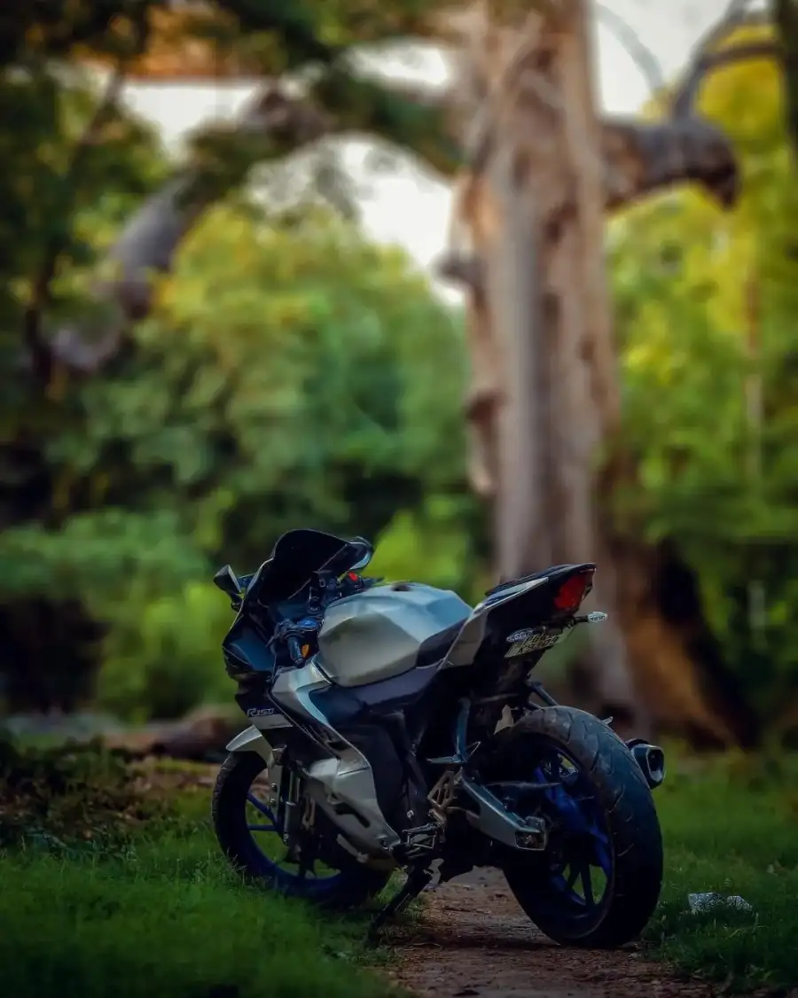 CB Motorcycle Parked On A Dirt Path Background