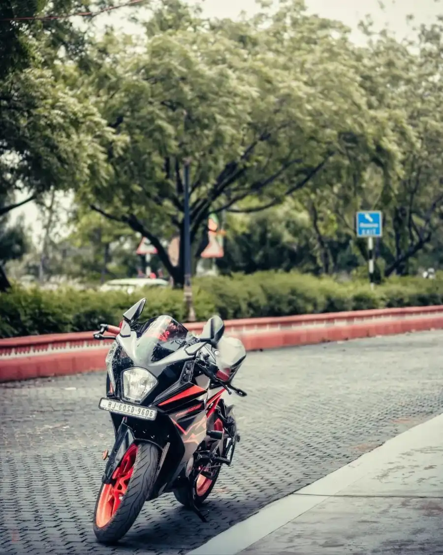 CB Motorcycle Parked On The Side Of A Road Background