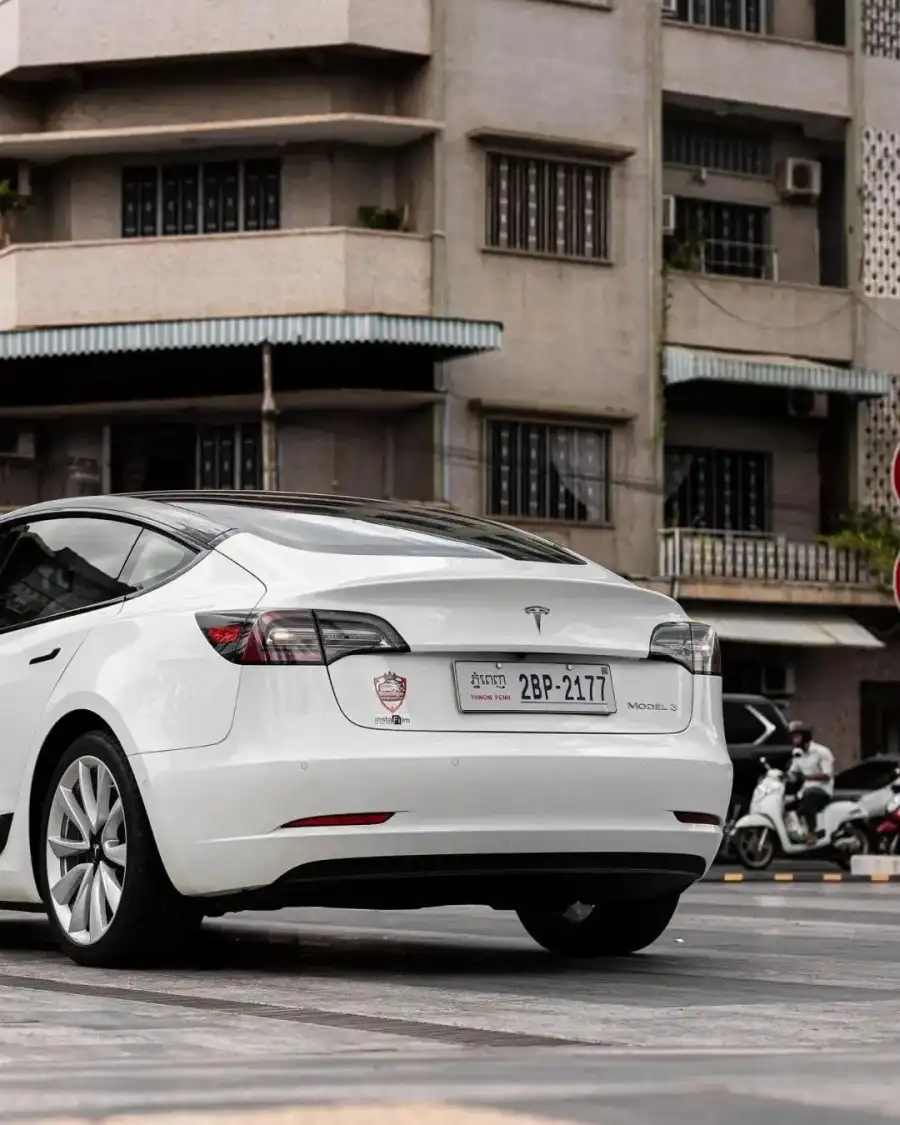 CB White Car Parked In Front Of A Building Background