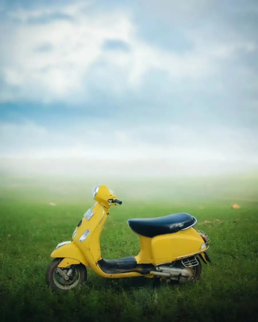 CB Yellow Scooter In A Grassy Field Background Free