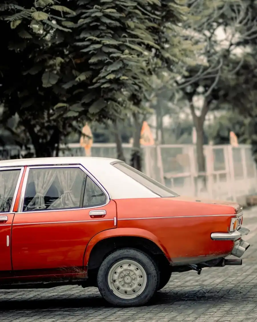 CBn Orange Car Parked On A Street Background HD