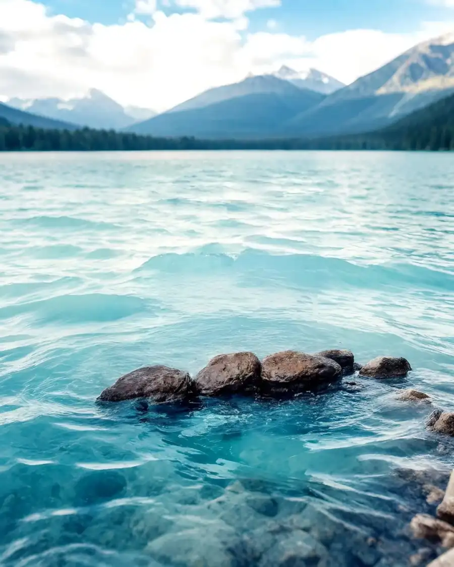 Editing Body Of Water With Rocks And Mountains In The Background