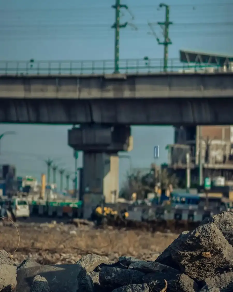 Editing Construction Vehicles Under A Bridge Background