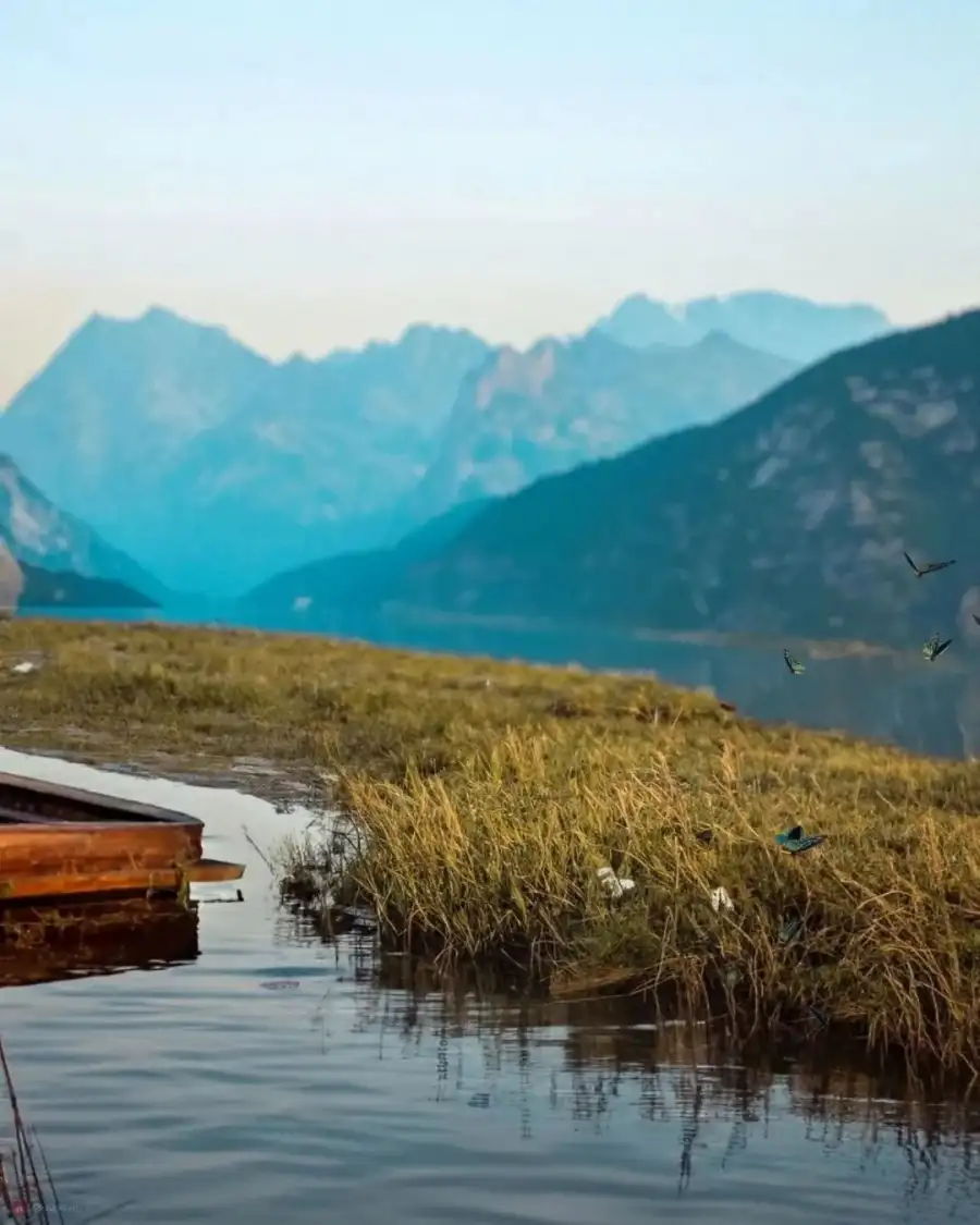 New Photo Editing Body Of Water With Grass And Mountains In The Background