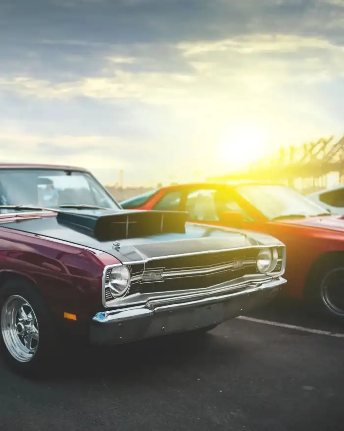 Photo Editing Old Couple Of Cars Parked In A Parking Lot Background