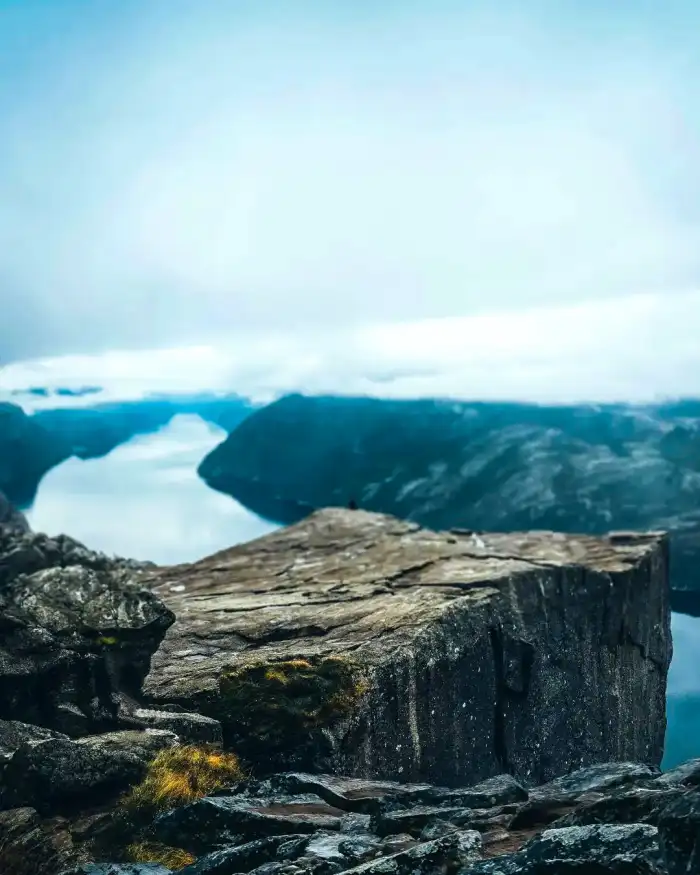 Photo Editing Rocky Cliff With A Body Of Water In The Background Background