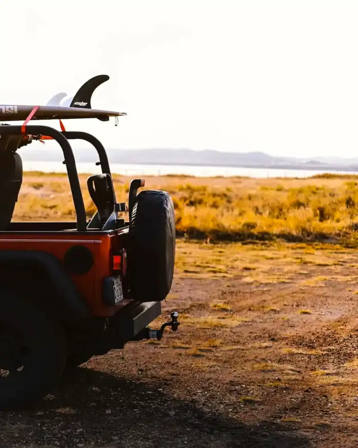 Photo Editing Vehicle With A Surfboard On The Back Background