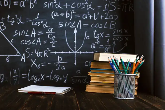 School Stack Of Books And Pencils On A Table Background