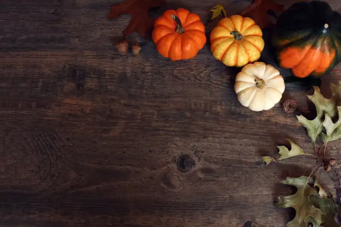 Thanksgiving Pumpkins And Berries On A Wood Surface Background